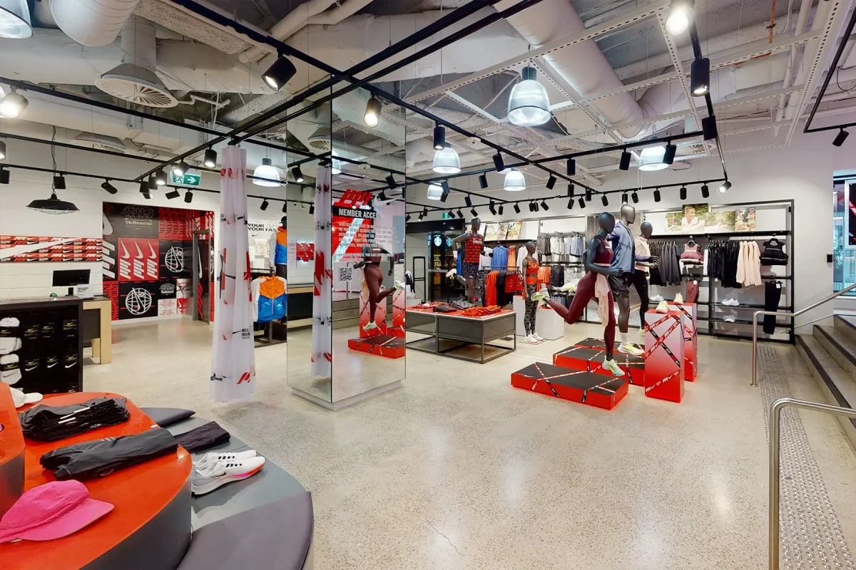 Interior of a modern clothing retail store with mannequins displaying athletic wear.
