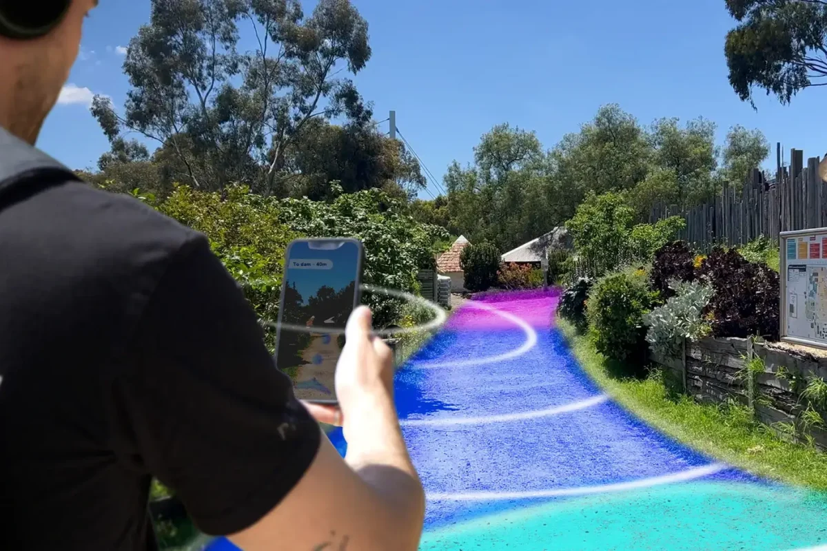 Man using a phone to record immersive 3D audio of a pathway with the Captur3D software